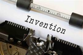 Close-up of the word 'Invention' typed on paper in a typewriter.